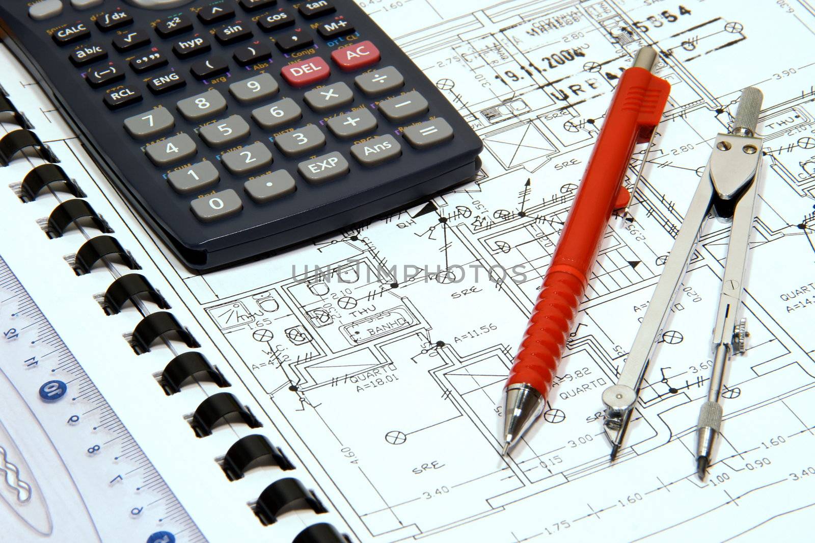 Blueprint with pen, calculator, ruler and compass