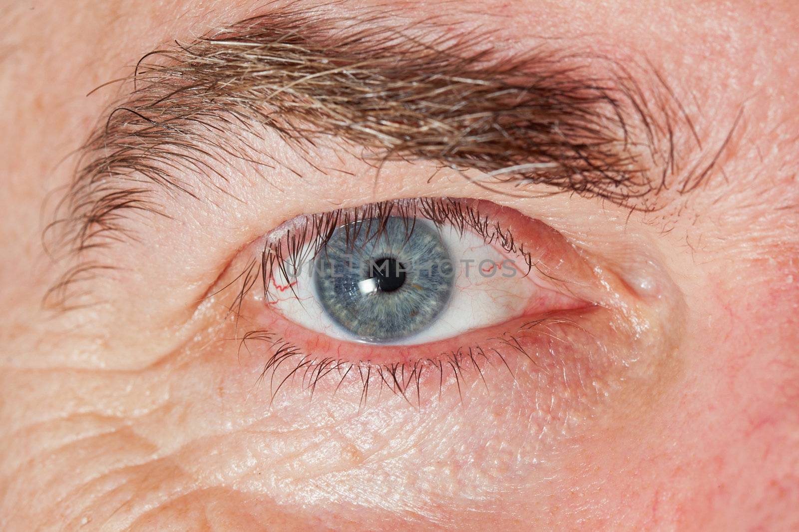 Blue Eye of mature man, close-up horizontal shot