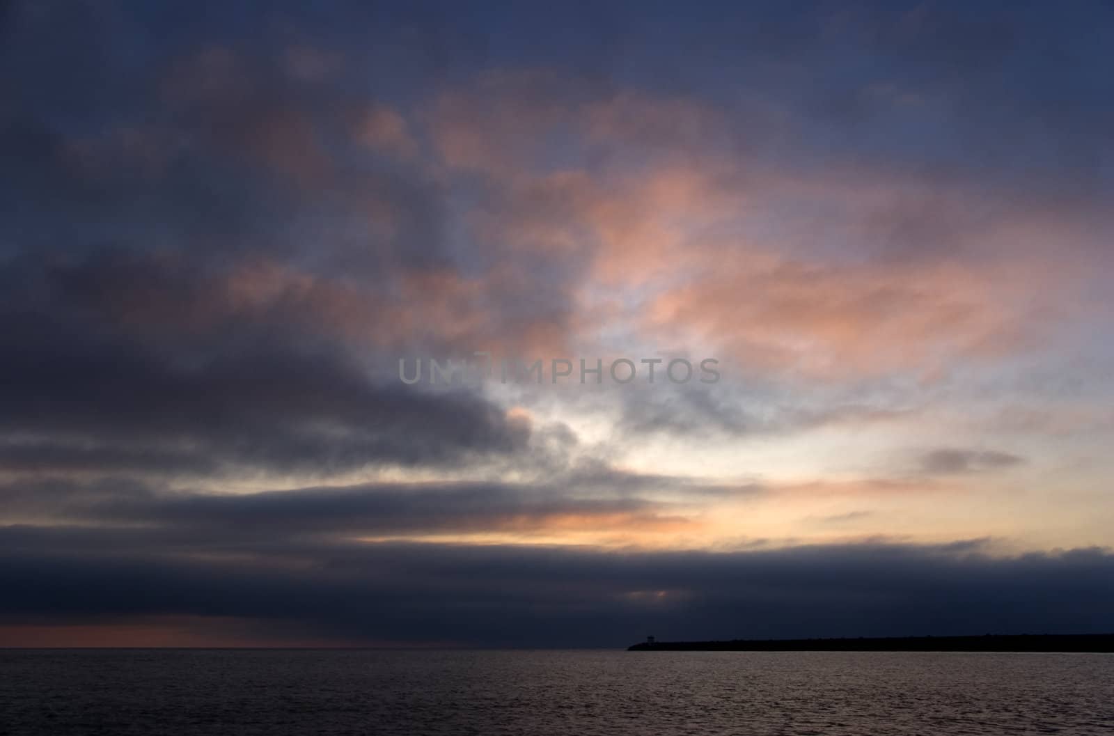 Cloudy Sunset Above the Sea with a Jetty