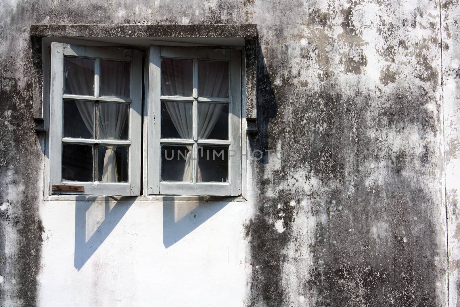 Exterior wall the window. Dirty old antique.