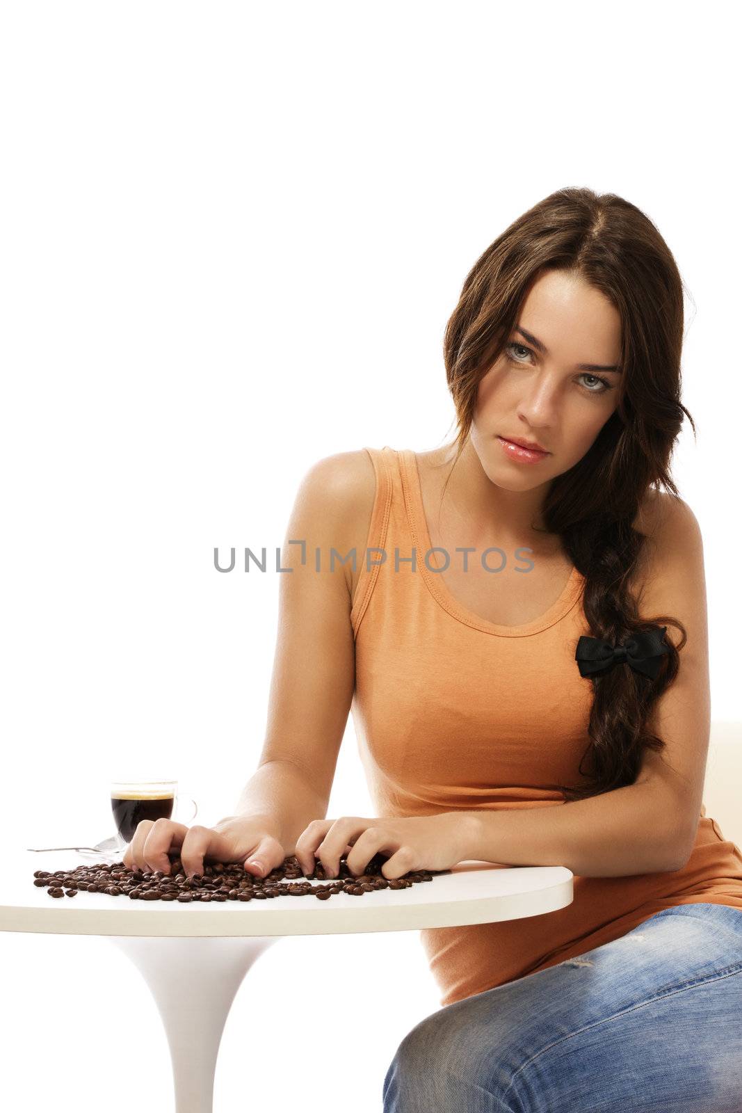 beautiful woman claw into coffee beans near espresso coffee on white background