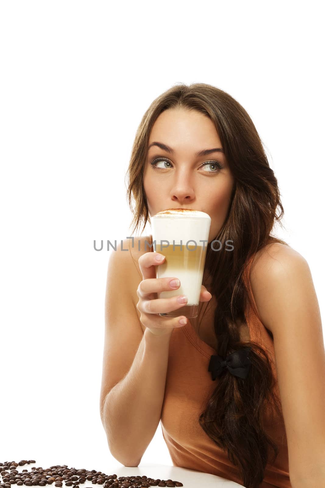 beautiful woman drinking latte macchiato coffee looking to side on white background
