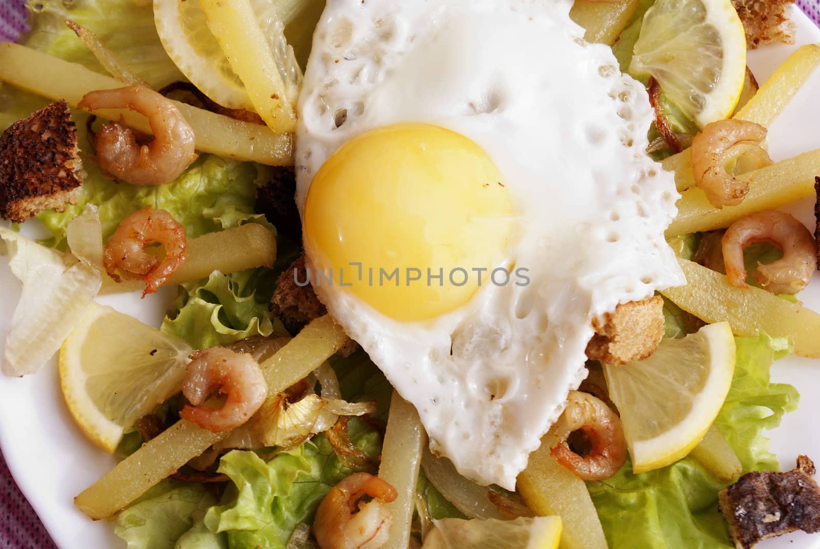 Creative fresh salad from seafood and fried eggs