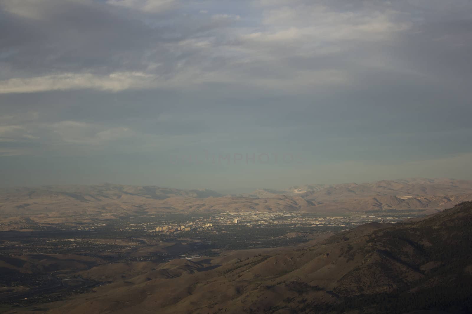 Clouds at dusk in the mountains. dark mountains and a bright blue sky.