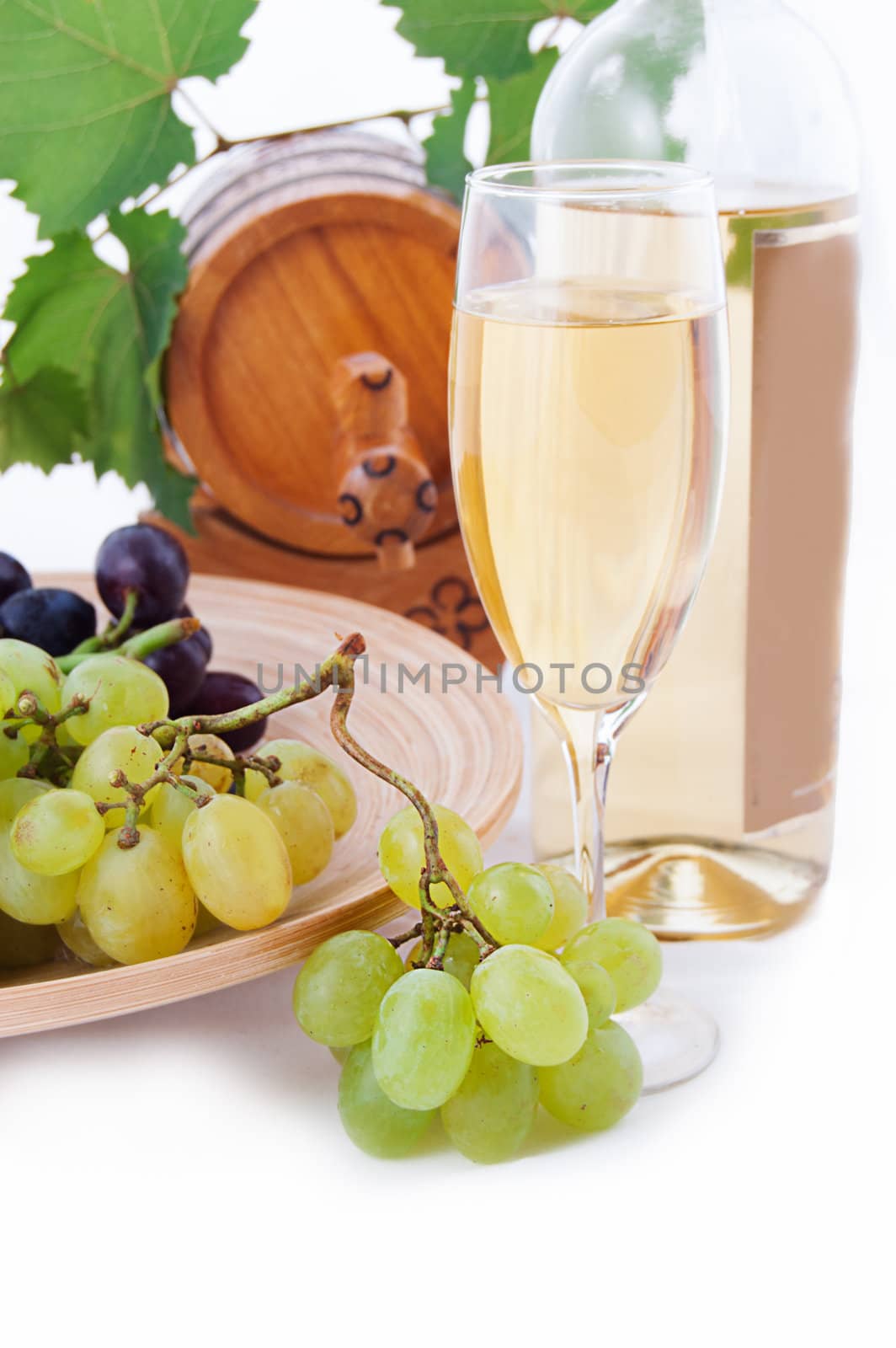 White wine bottle, glass and cask with grapes over white