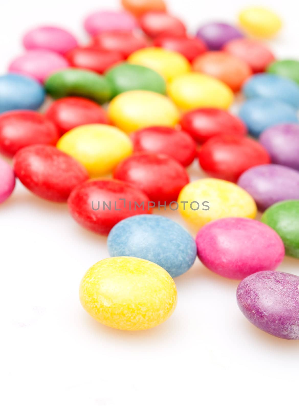 Round Candies in Many Colors on White Background
