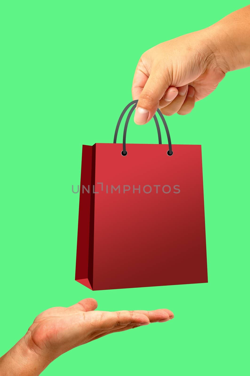 Shopping bag in hand isolated on green background