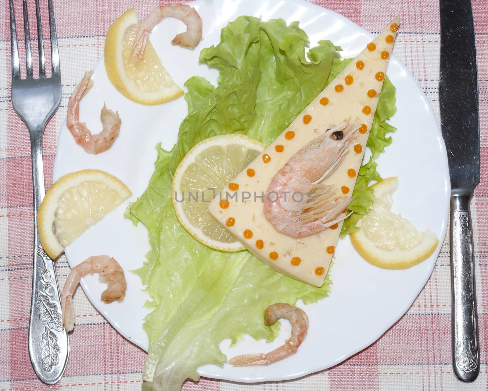 Creative salad from fresh seafood and cheese with leaves of lettuce
