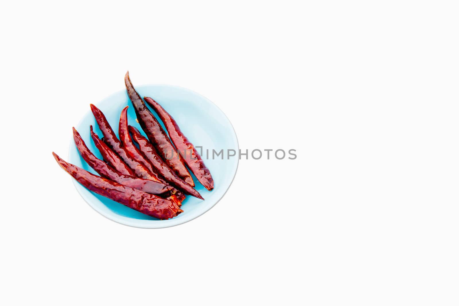 red chili peppers in a bowl by 9dap