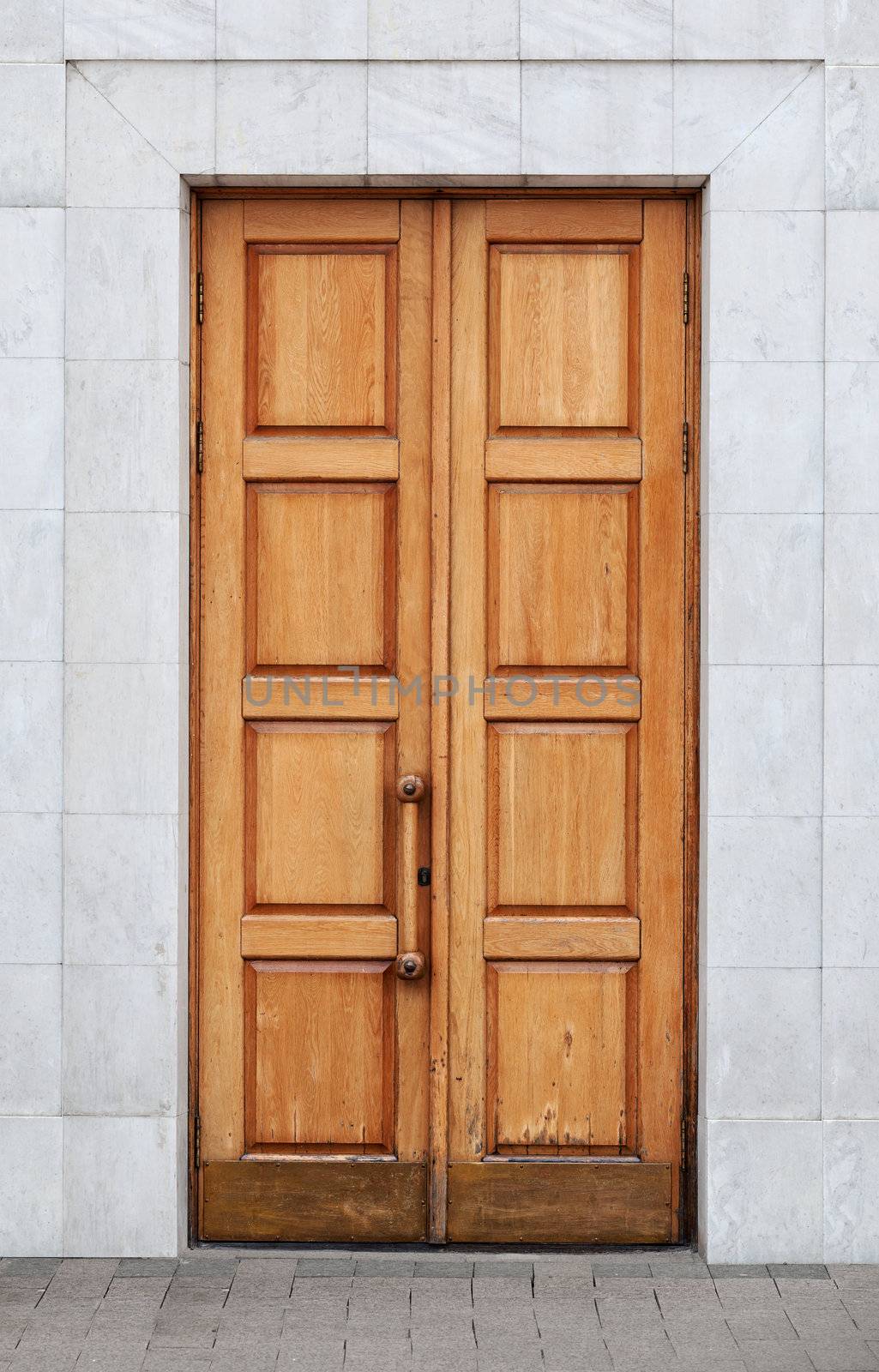Old wooden door and a marble wall
