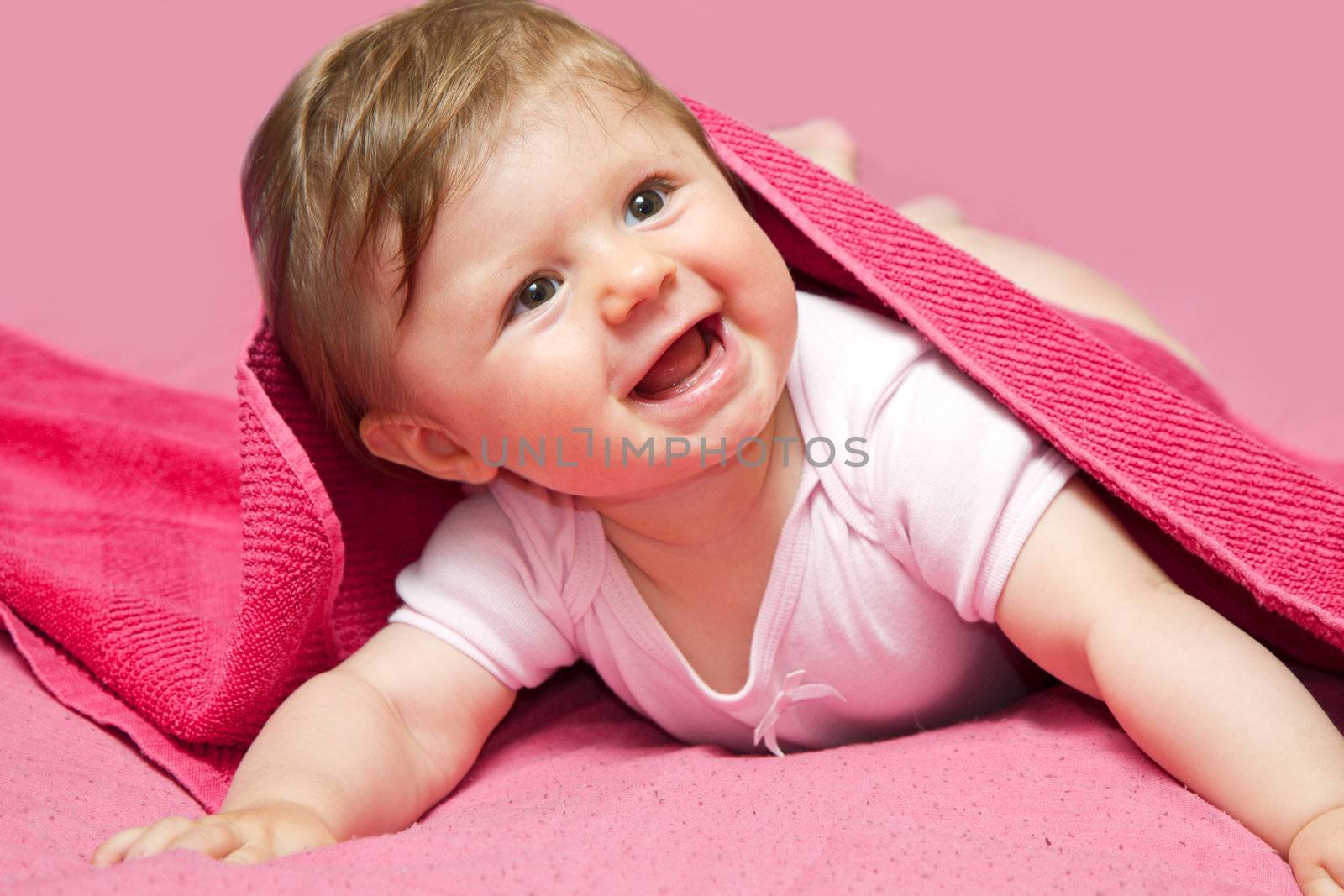 An adorable, laughing baby looking at camera