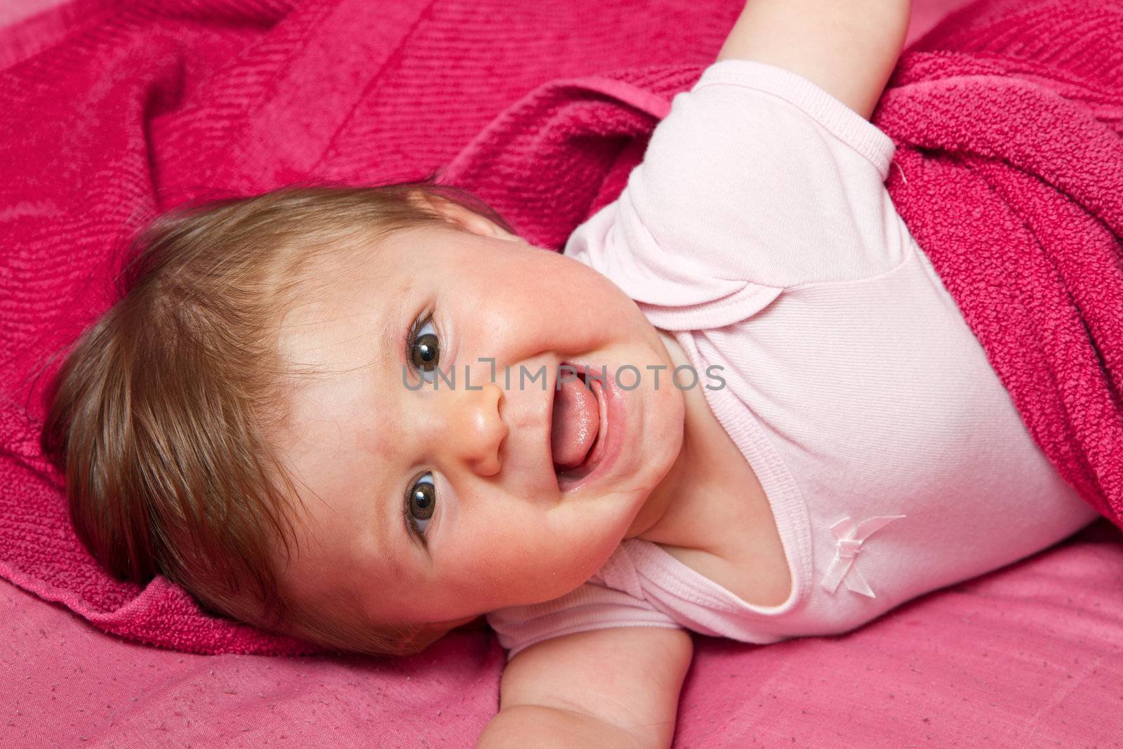 An adorable, laughing baby looking at camera by lsantilli