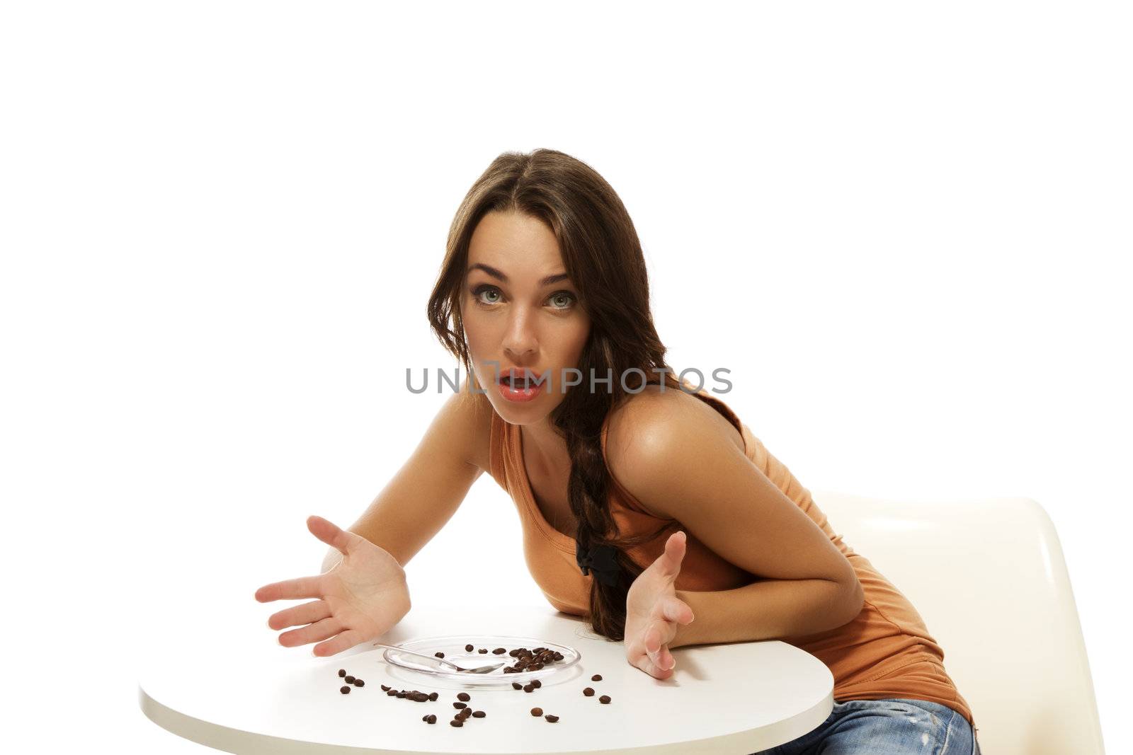 young woman missing her coffee sitting at a table on white background