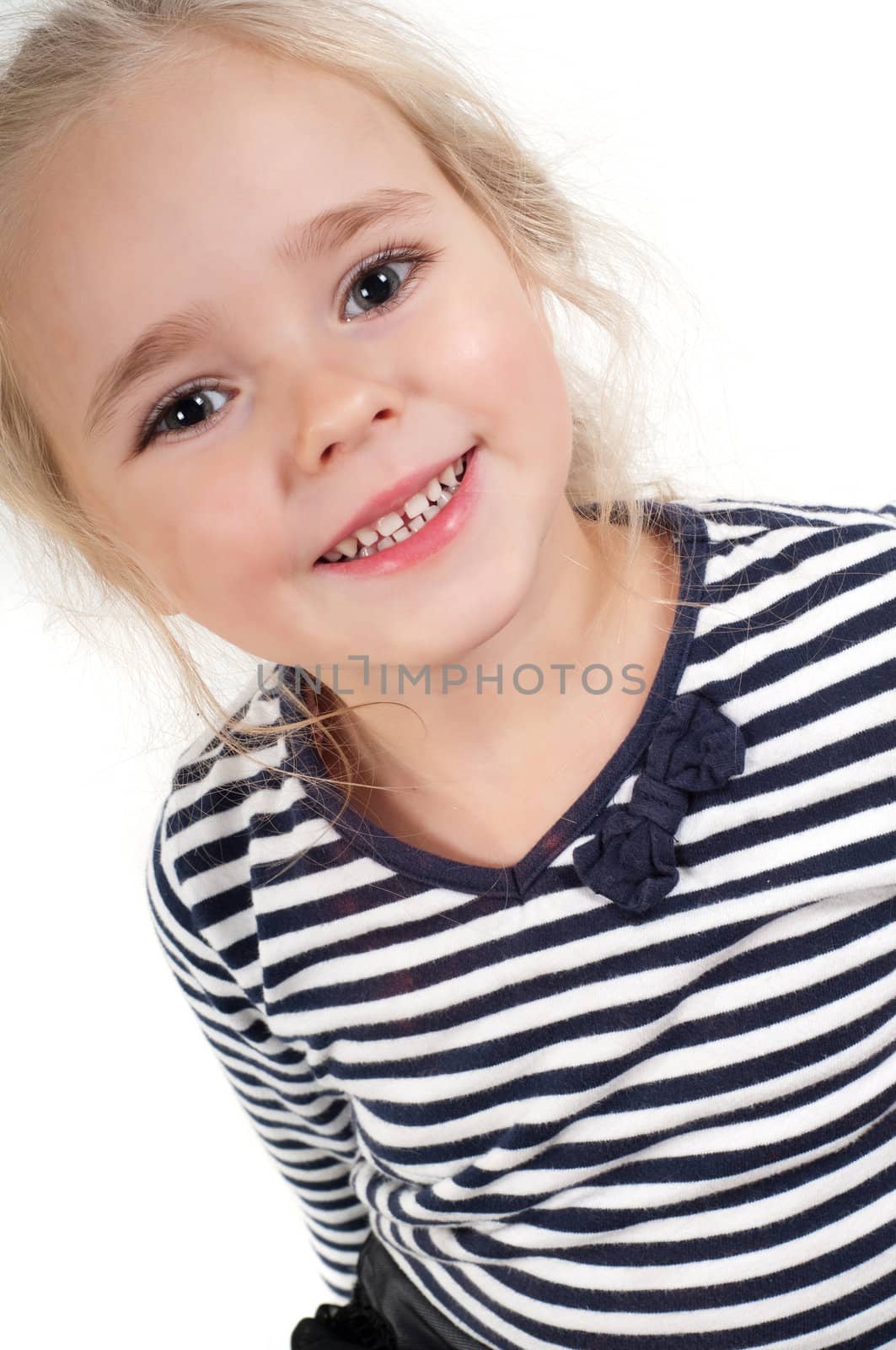 Studio portrait of little cute girl in striped top