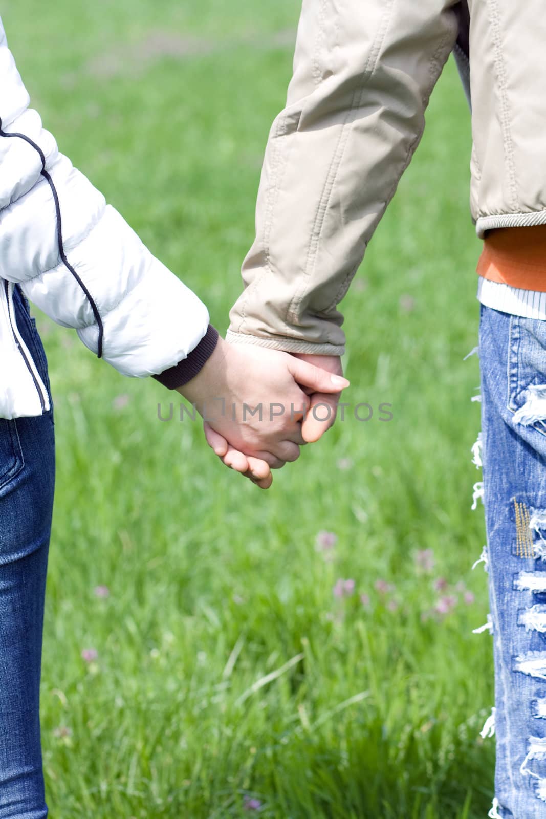 Detailed view of a young couple holding hands