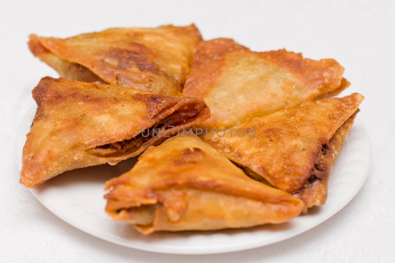 Triangular shaped Ethiopian fried lentil Samosa served on a plate