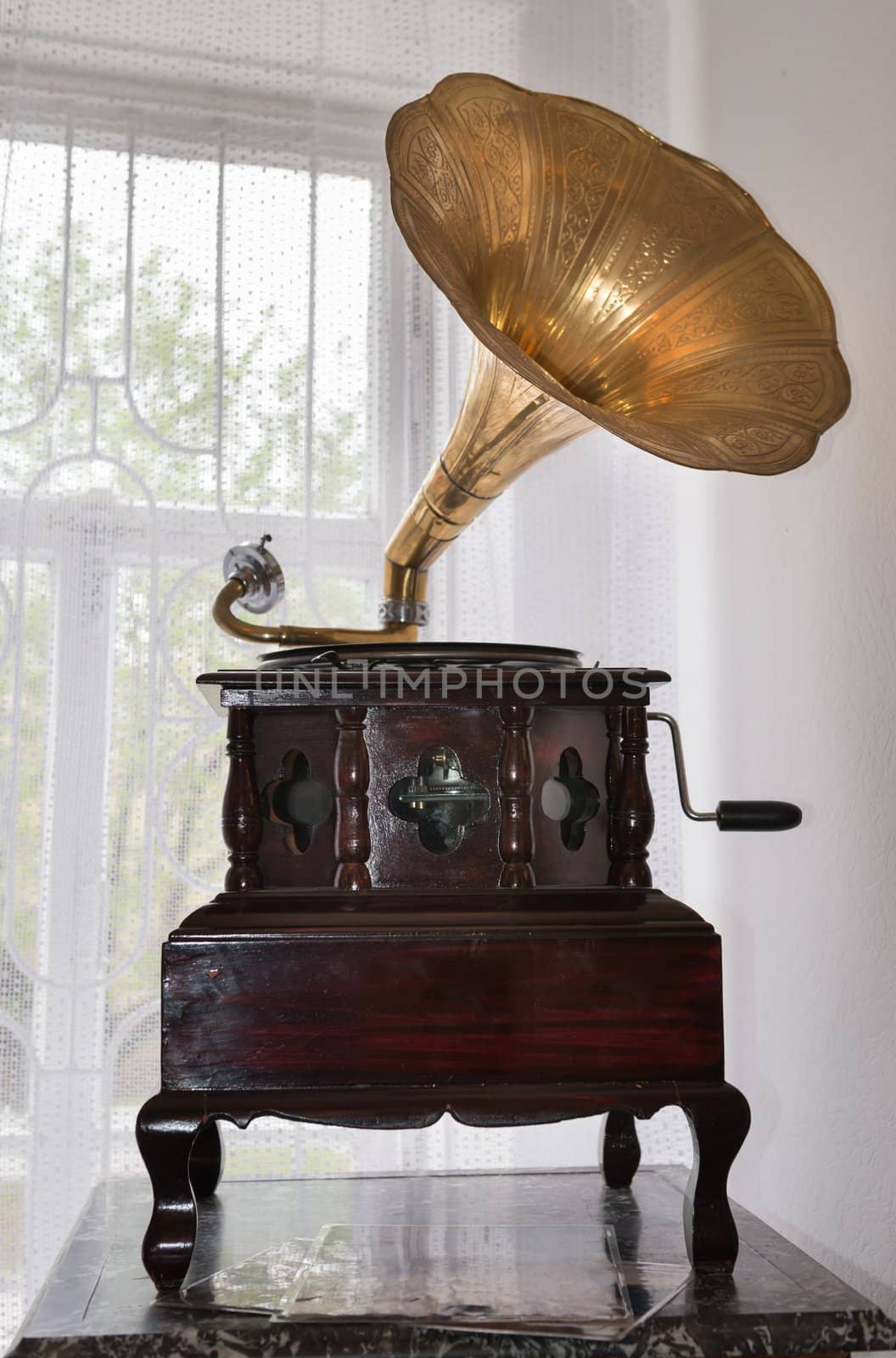 Gramophone in front of a window in vintage interior