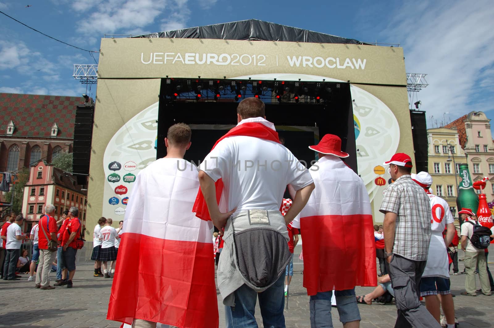 WROCLAW, POLAND - JUNE 8: UEFA Euro 2012, fanzone in Wroclaw. Three Polish fans in front of stage  on June 8, 2012.