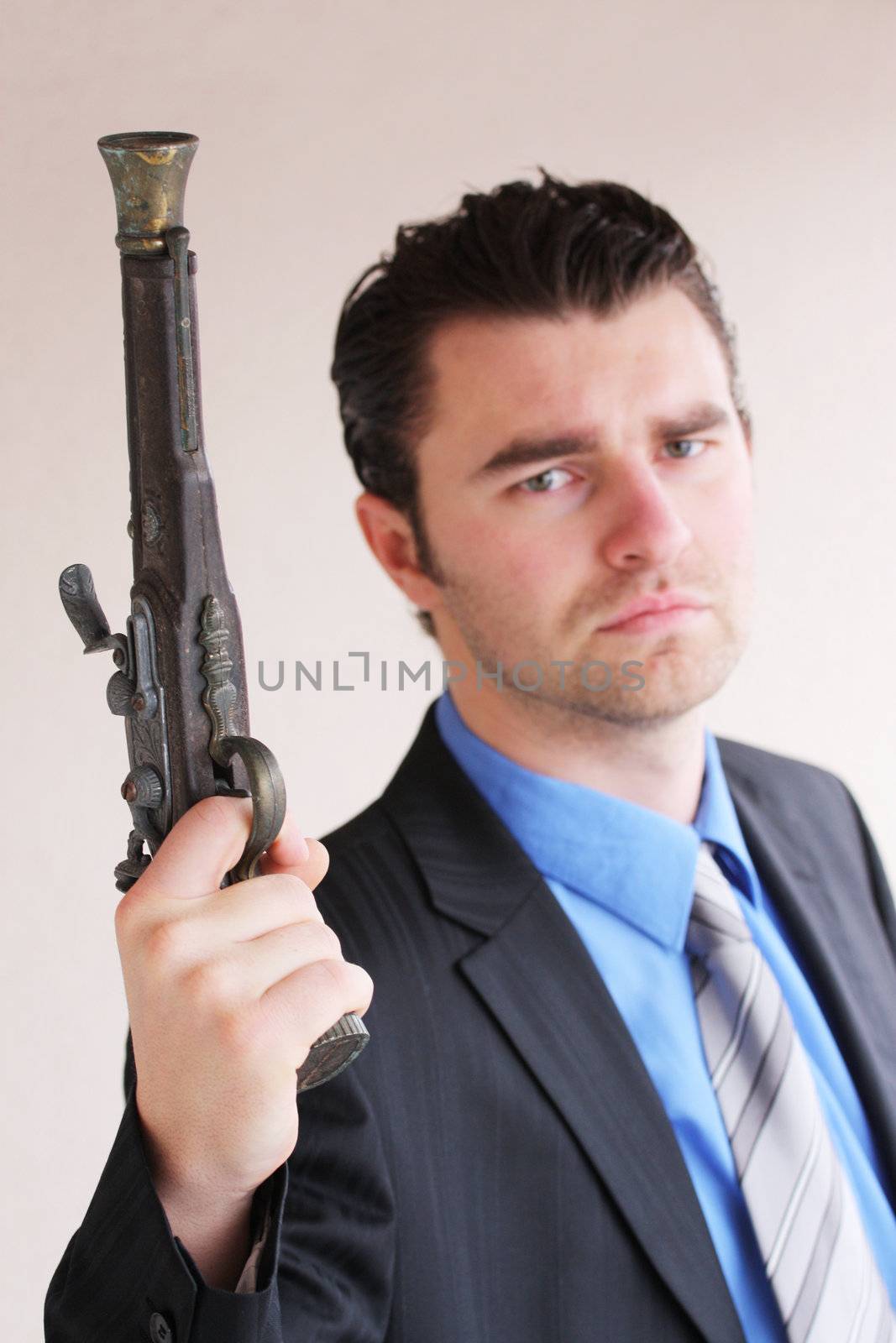 Businessman with a handgun by photochecker