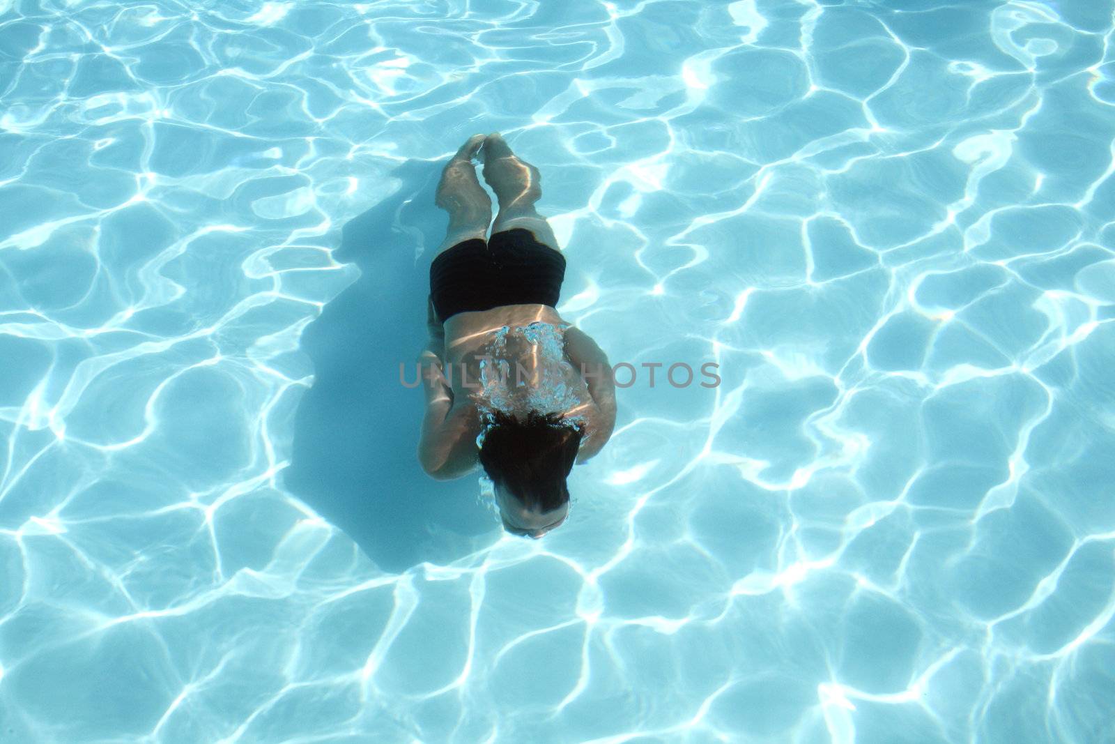 posing in the swimming pool for the photographer