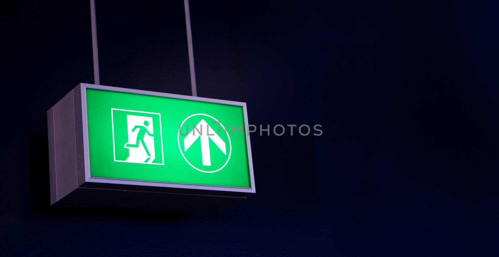 Emergency exit sign in modern offices inside an industrial plant