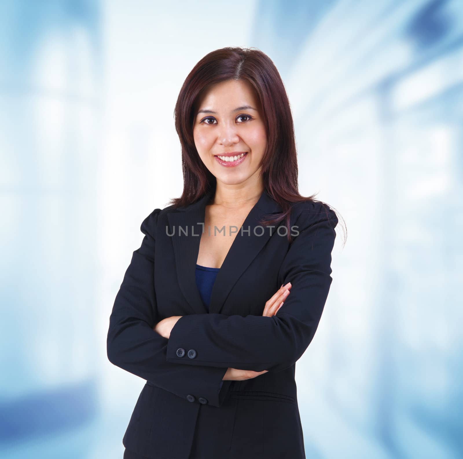 Mixed race Mid adult Asian woman standing on office background