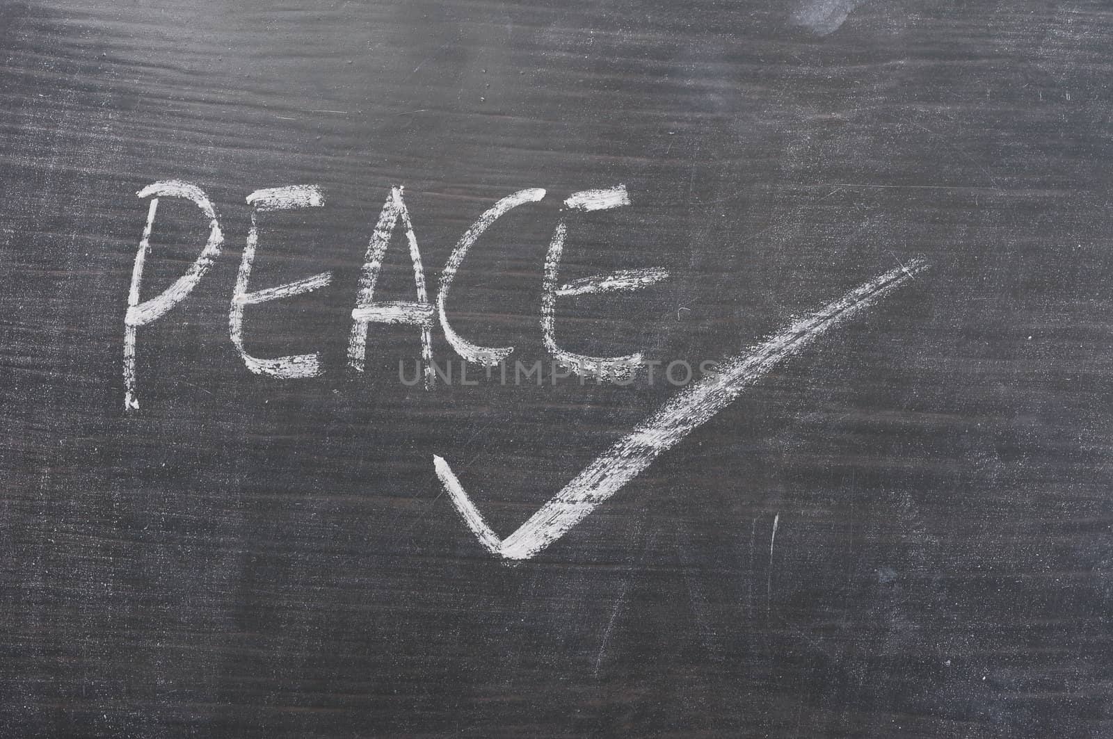 Peace - word written on a blackboard by bbbar