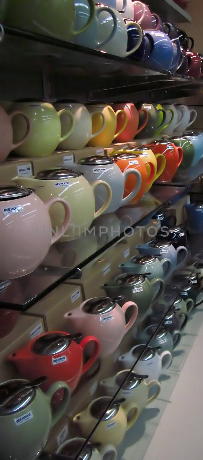A photograph of various teapots for sale in a grocery store.