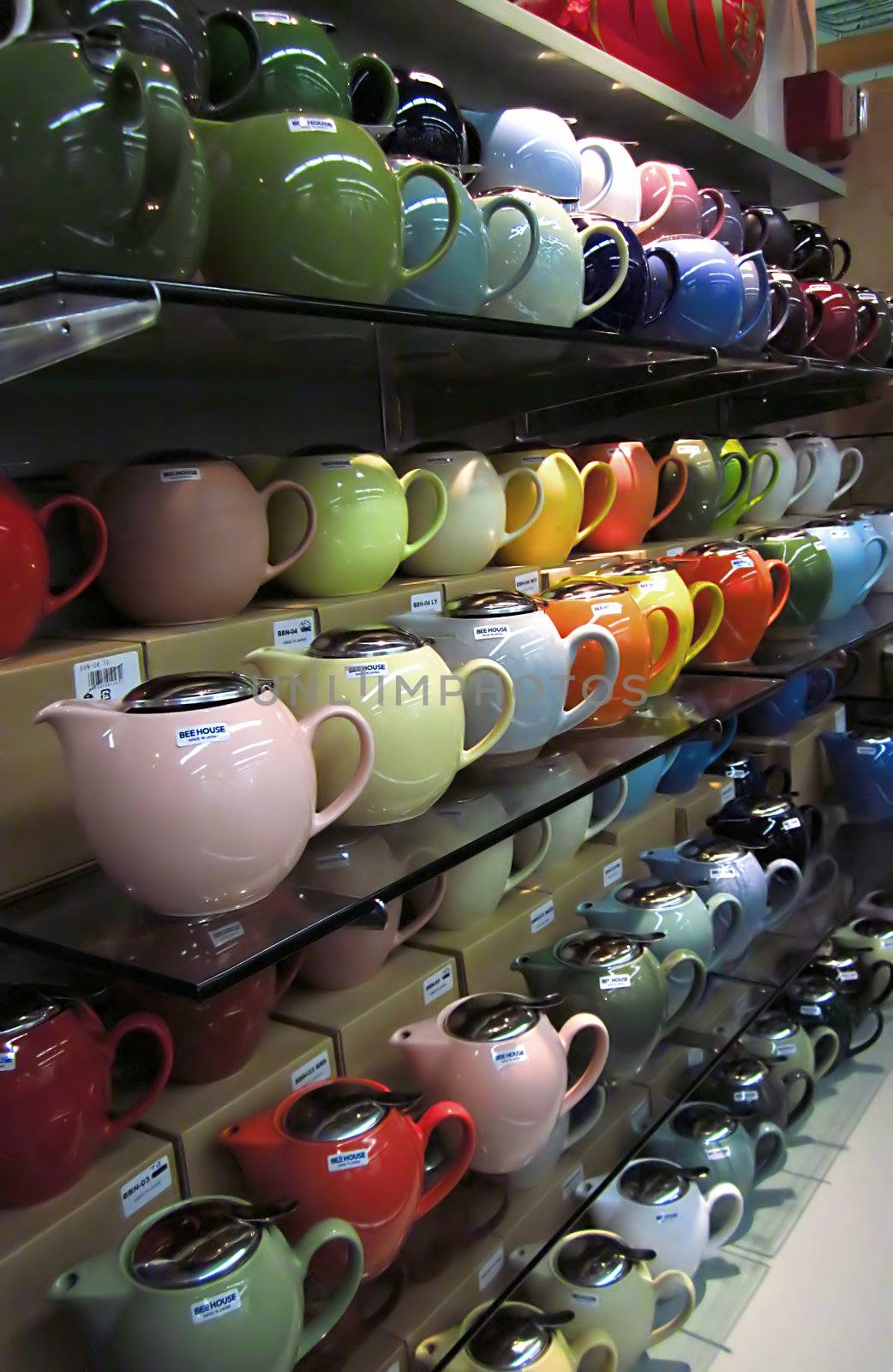 A photograph of various teapots for sale in a grocery store.