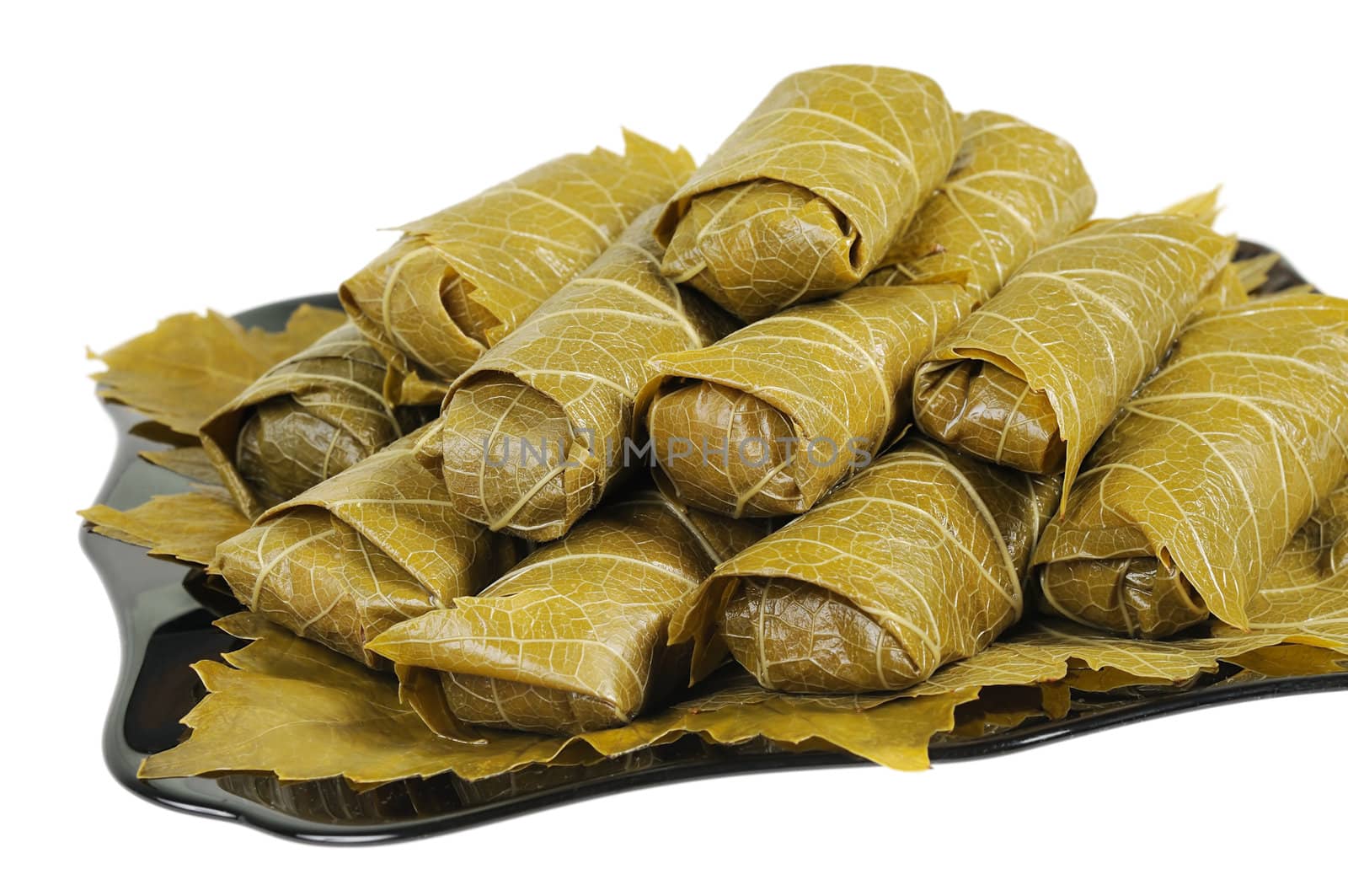 Dolma on a black plate. Isolated on white background.