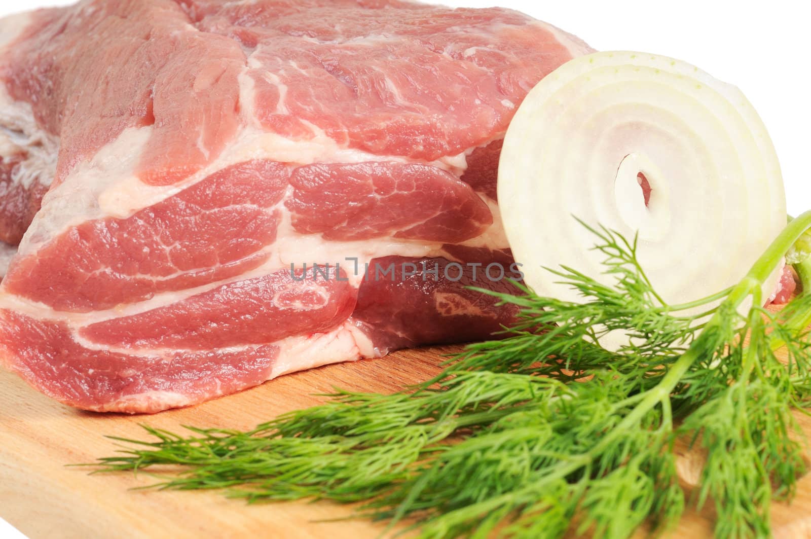 Piece of pork for roasting on a wooden board. Isolated on white.