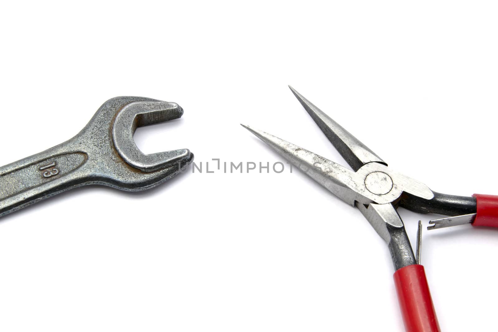 pliers and wrench closeup on white