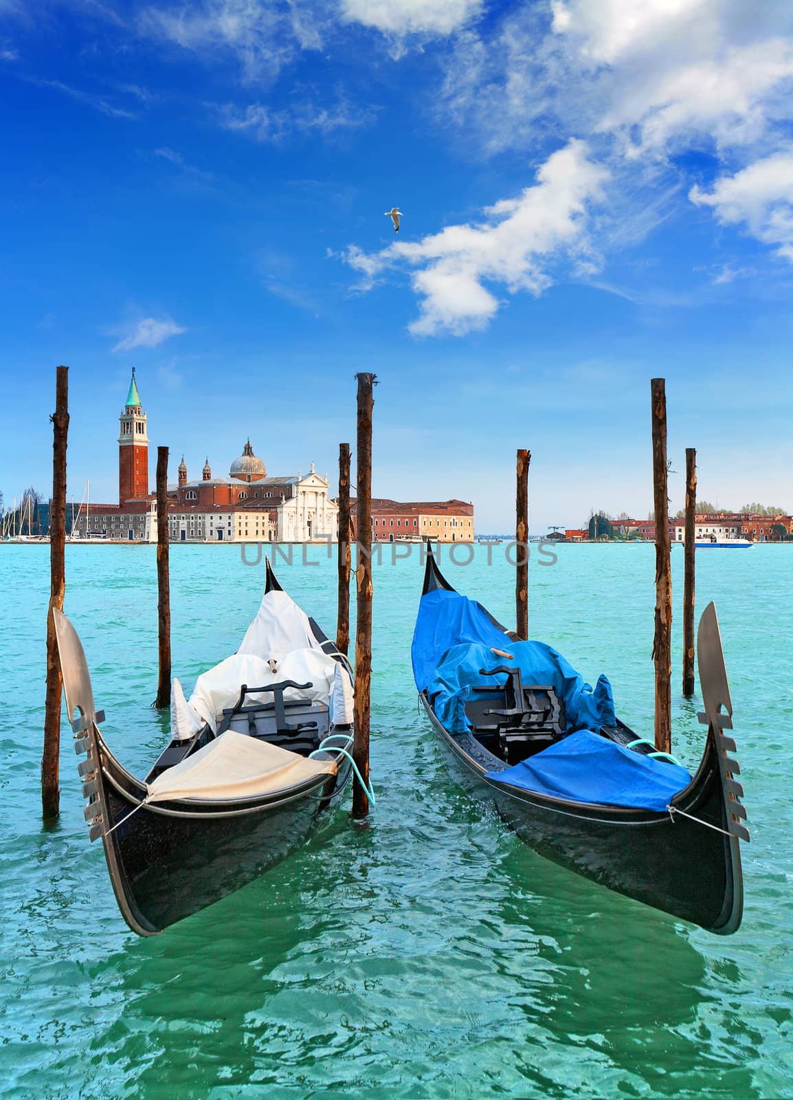  Gondolas. Venetian Lagoon. San Giorgio Maggiore. Venice. Venice is a city in northeast Italy which is renowned for the beauty of its setting, its architecture and its artworks. It is the capital of the Veneto region.