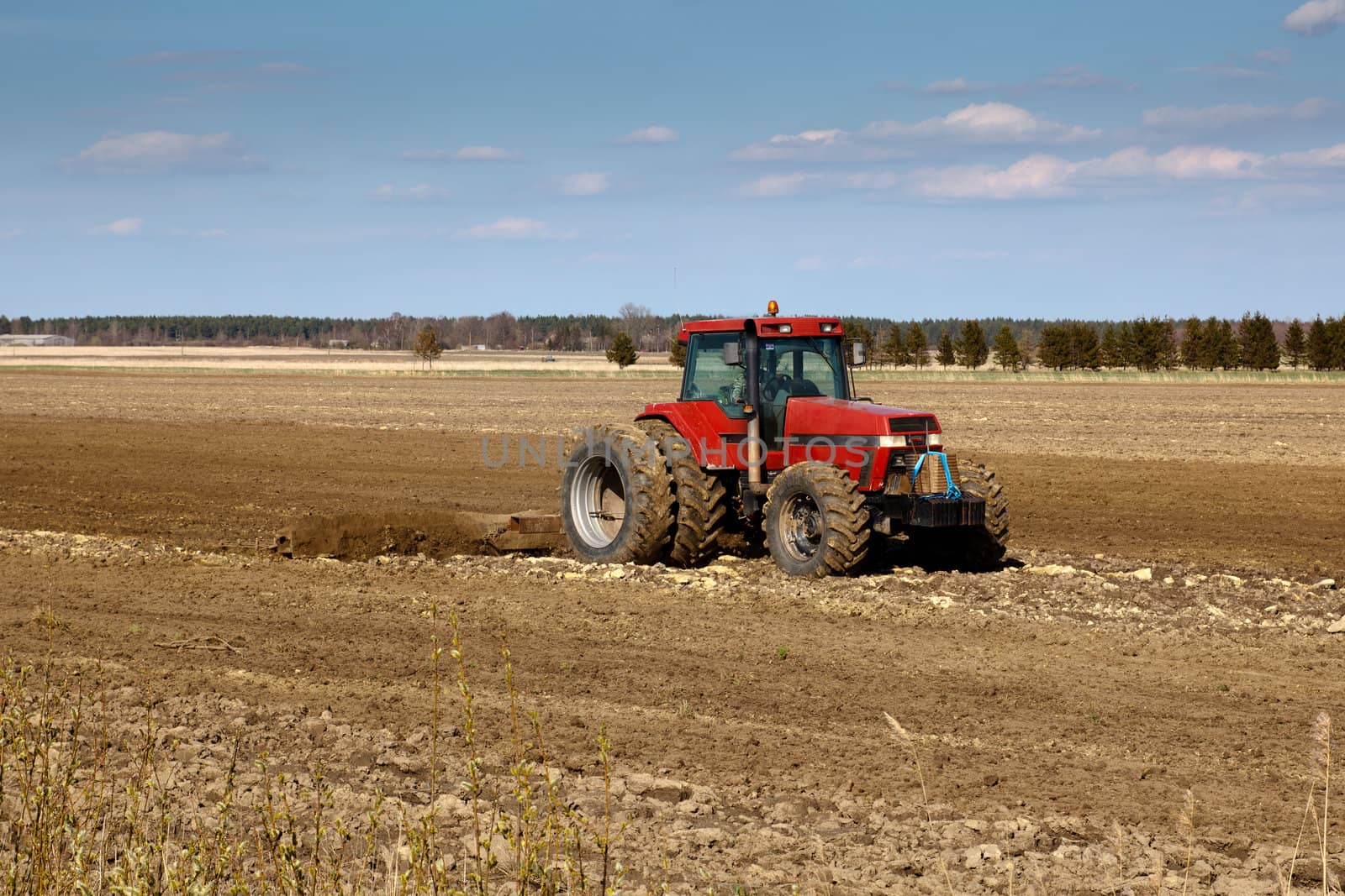 tractor cultivated fields in early spring