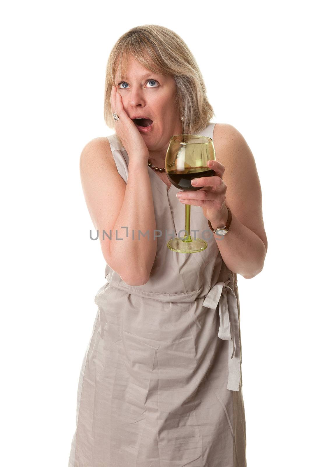 Attractive Mature Woman with Shocked Horrified Expression Holding Large Glass of Red Wine Isolated