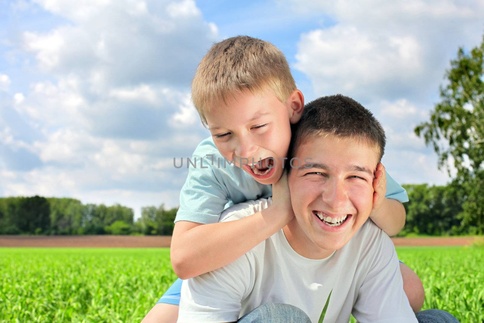 happy brothers in the summer field