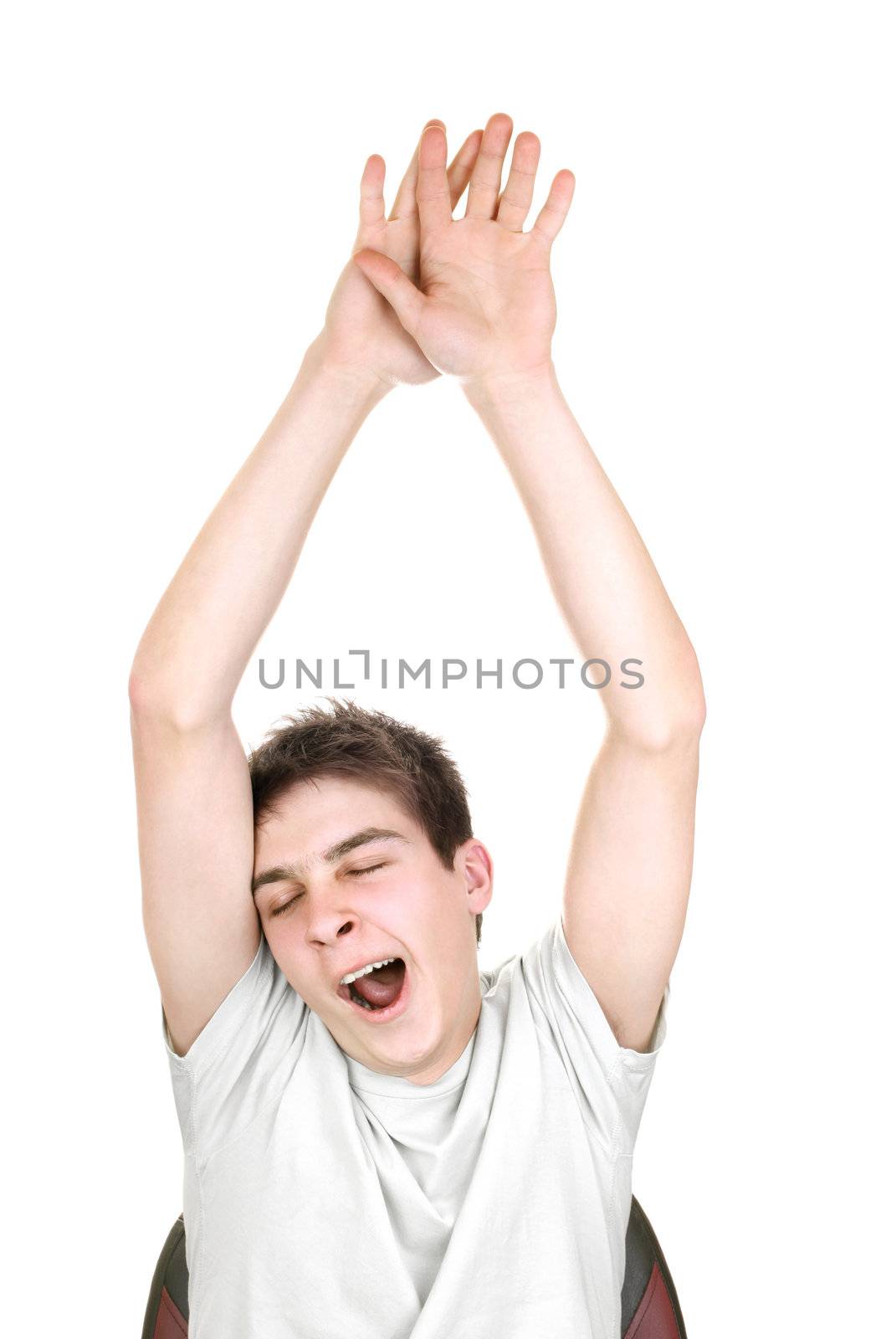 yawning teenager with hands up on the white background