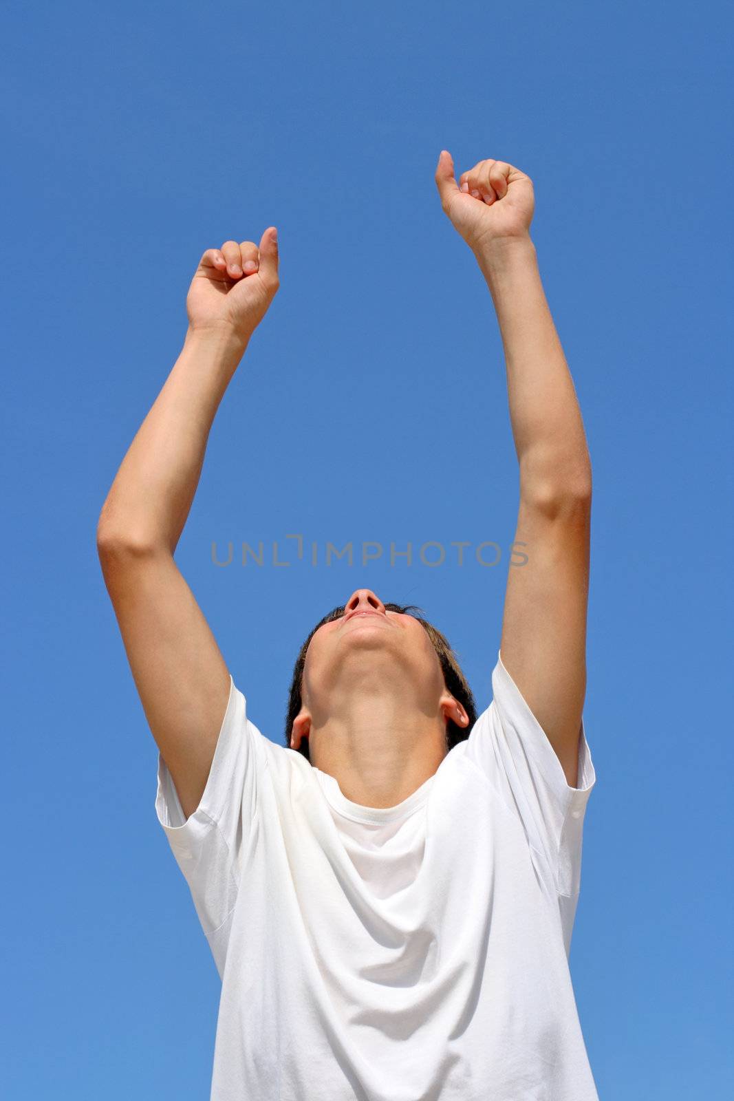 happy person jumping on blue sky background