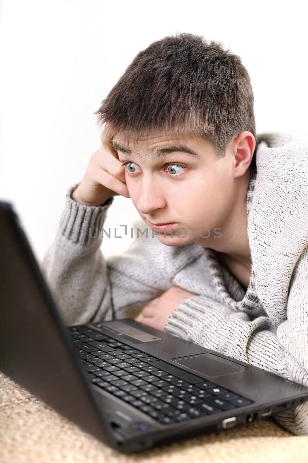 amazed young man with notebook on sofa