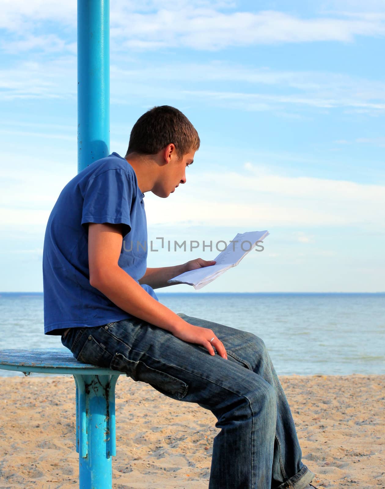 teenager reading letter on the empty beach