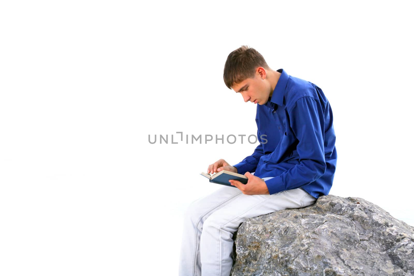 teenager sitting with a book on the stone. isolated on the white