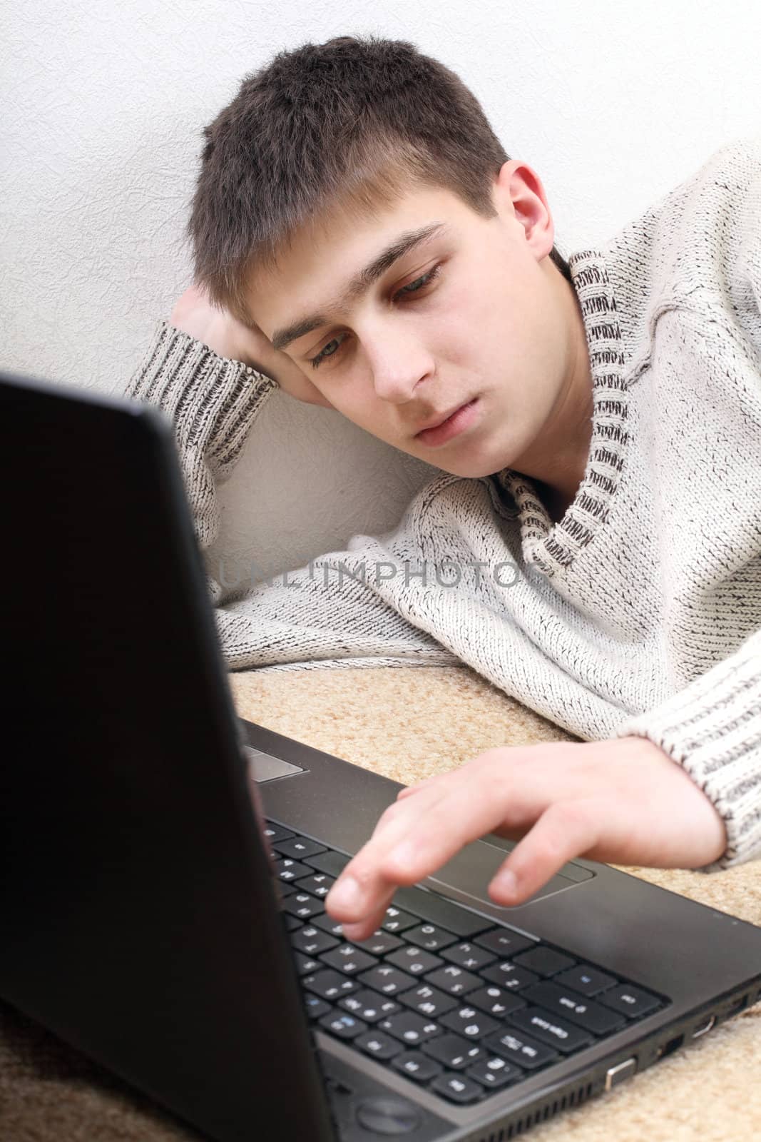 young man with notebook on sofa