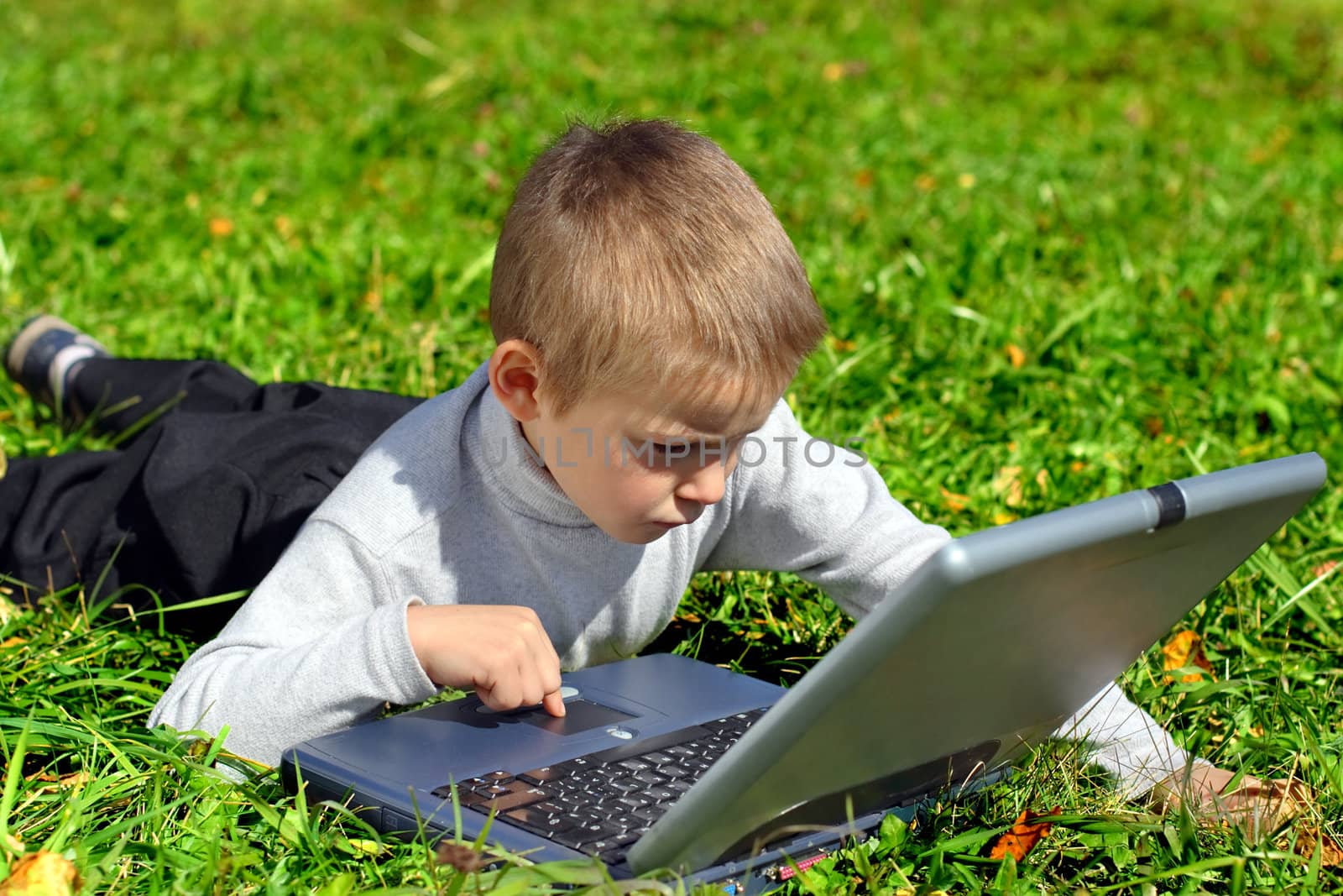 boy with notebook on the summer meadow