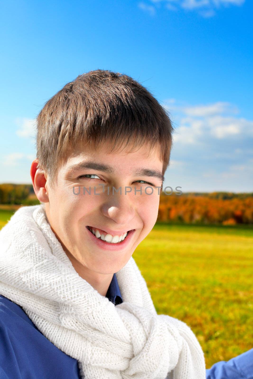 happy and smiling teenager portrait in the autumn field