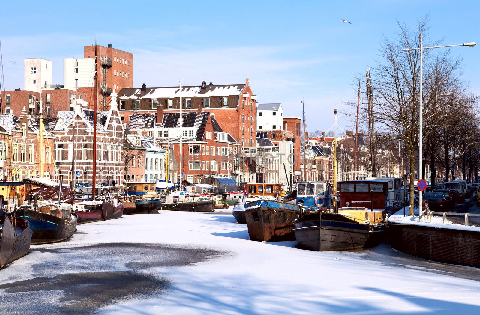 view on white channel covered with snow in Groningen, Netherlands