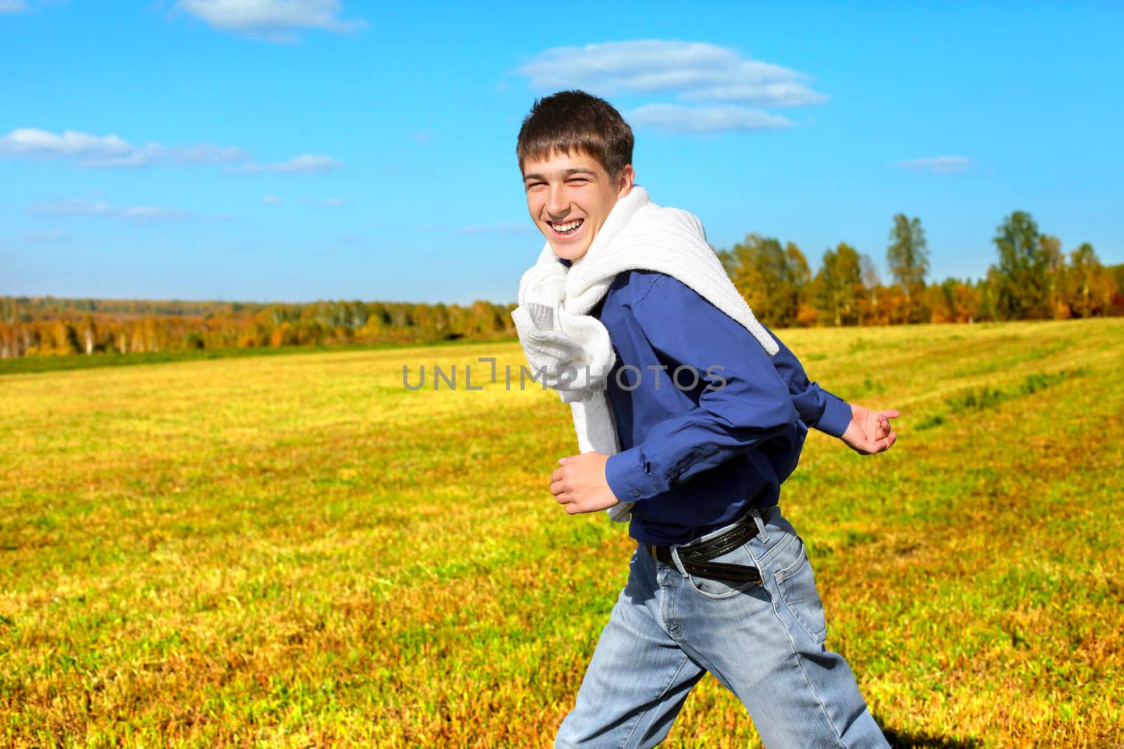 happy teenager running in the autumn field