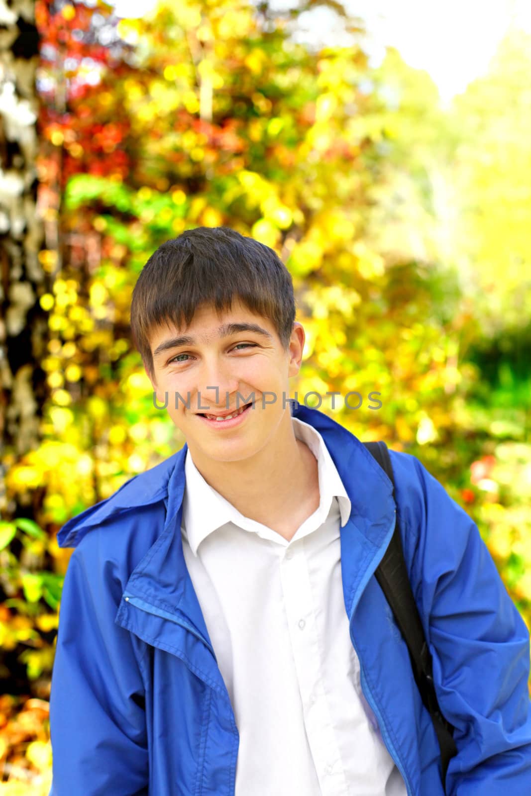 young man portrait in the autumn park