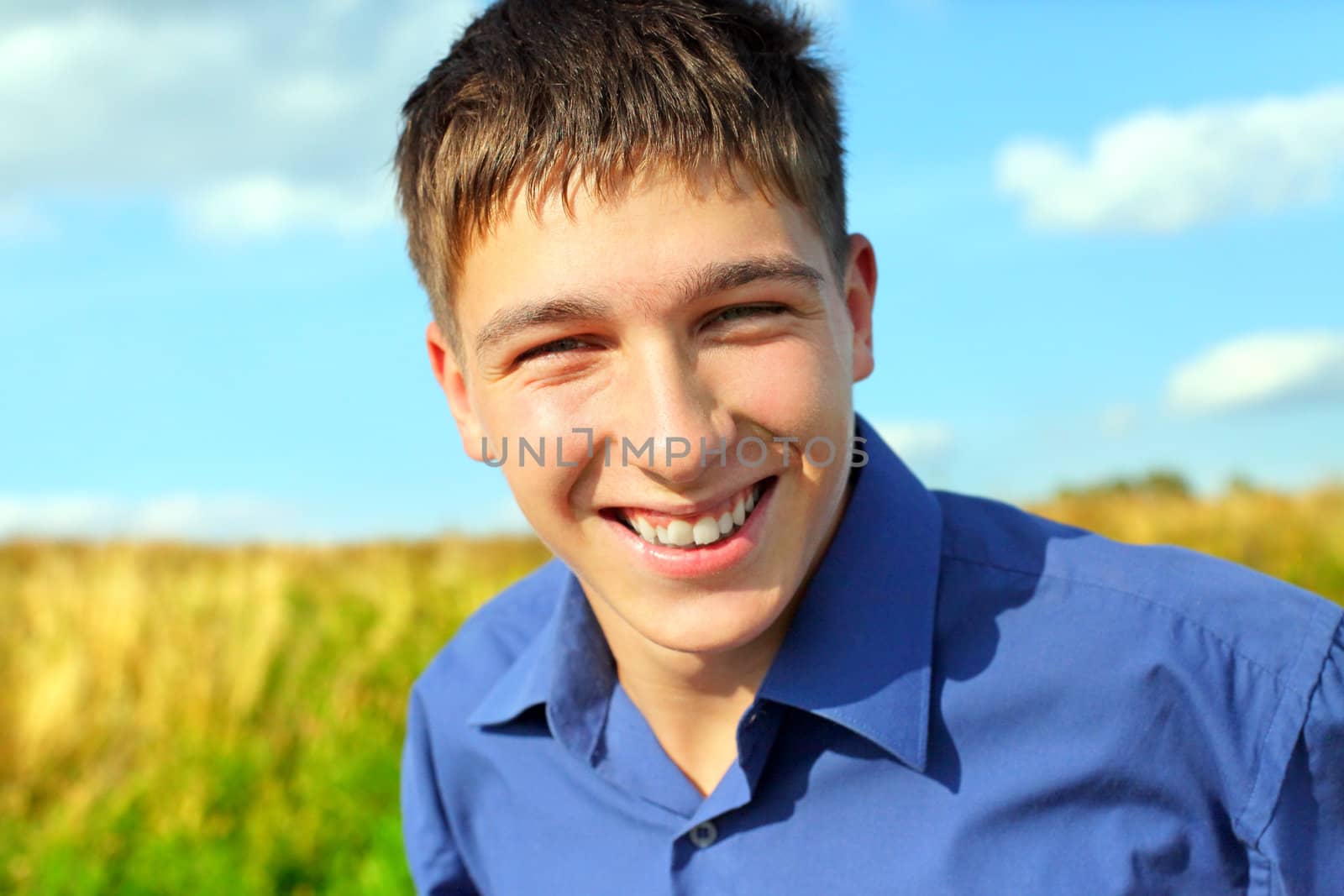 happy and smiling teenager portrait in the field