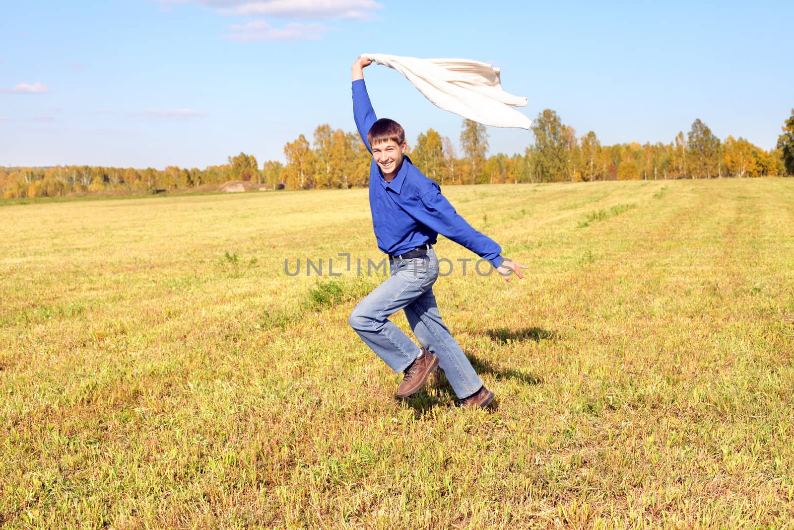 happy teenager running on the autumn field