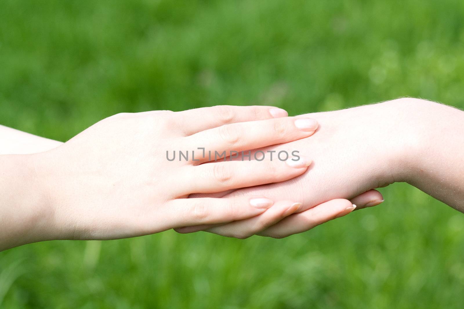 Two people holding hands for helping